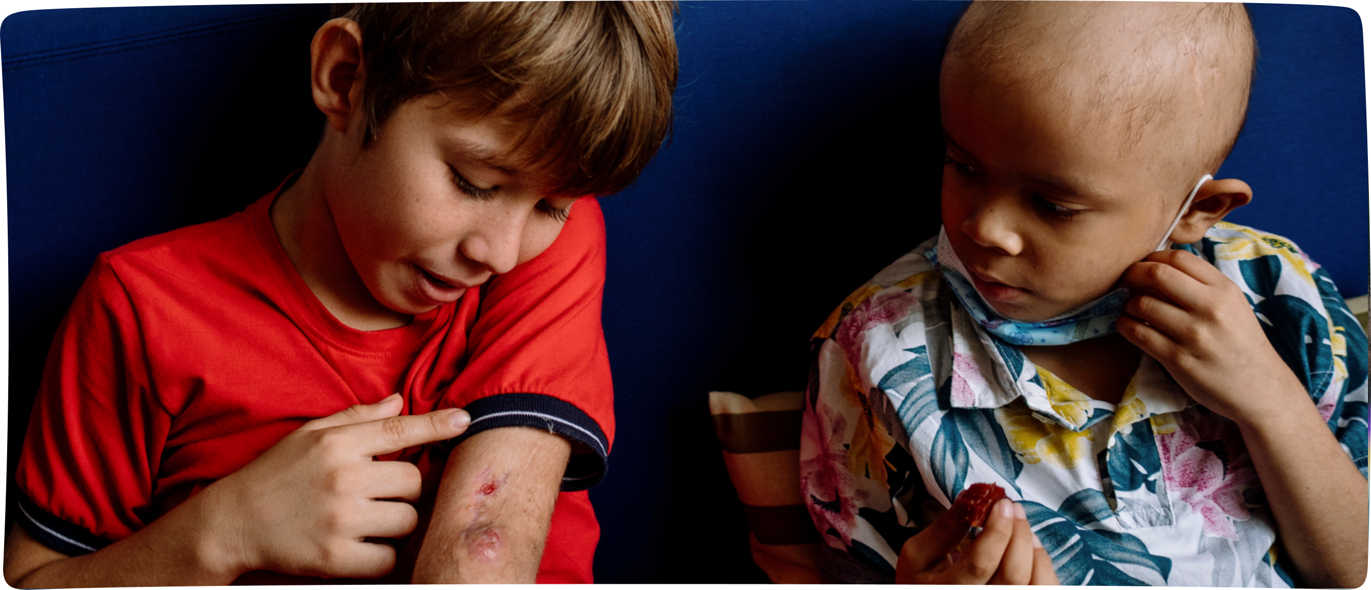 Members of a corporate partner donating their time and hospitality, three men at varying distance, one in focus smiles at the camera