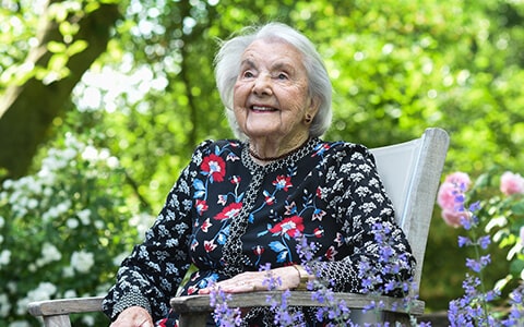 Dr Evans sitting and enjoying the garden