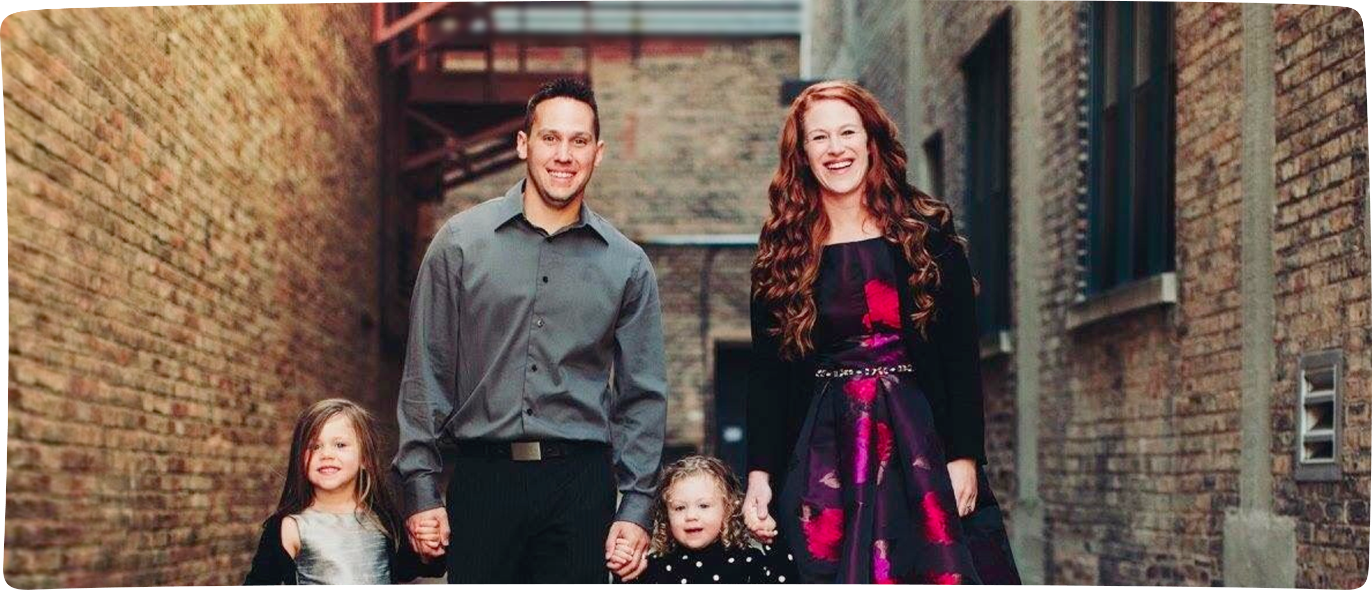 The Ledvinas, an RMHC family, posed holding hands in a picturesque brick-lined alley