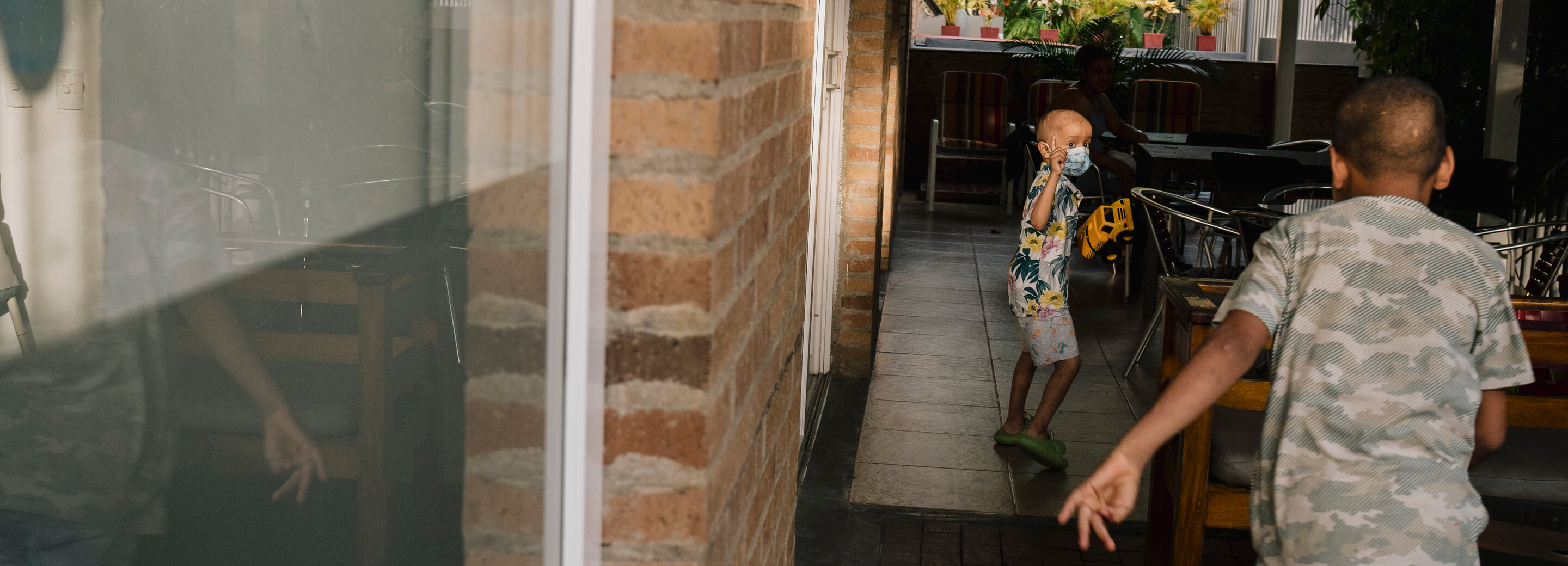 Ronald McDonald House parents surround their infant in an embrace on a hospital bed