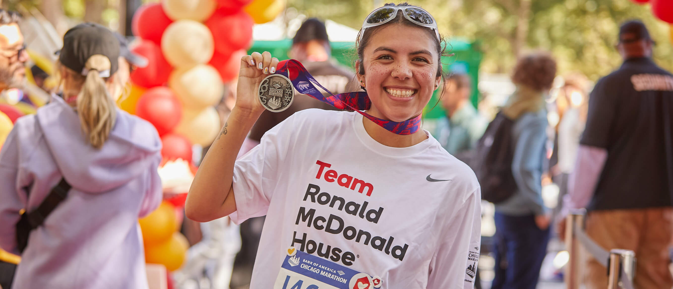 Smiling Ronald McDonald House Marathon Runner with medal