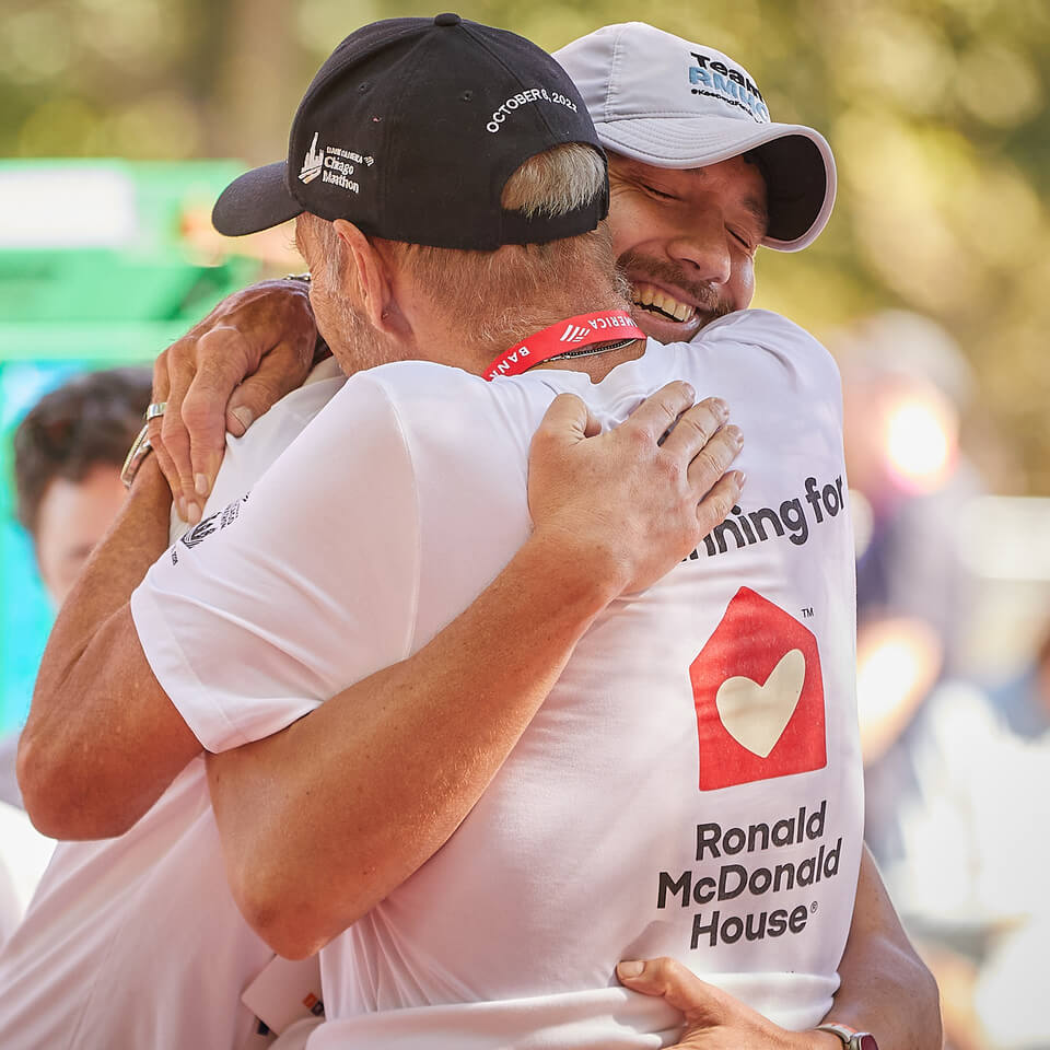 Two Ronald McDonald House Marathoners hugging after the finish line