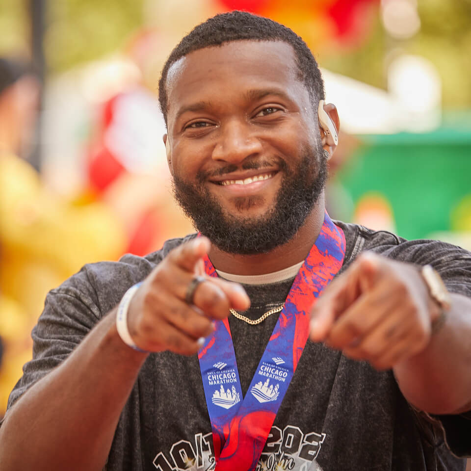 Ronald McDonald House Marathon Runner smiling and pointing at the camera